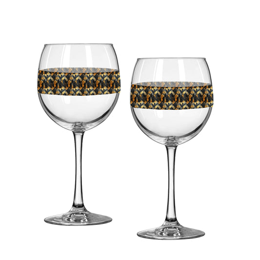 Two balloon wine glasses with charcoal and bronze geometric design on a white background