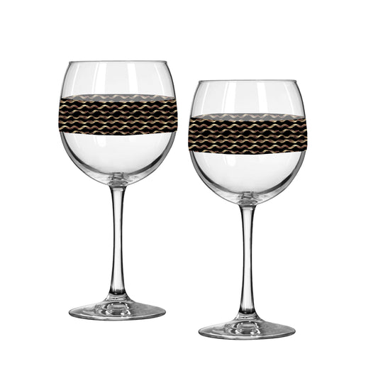 Two wine glasses with decorative black bands on a white background