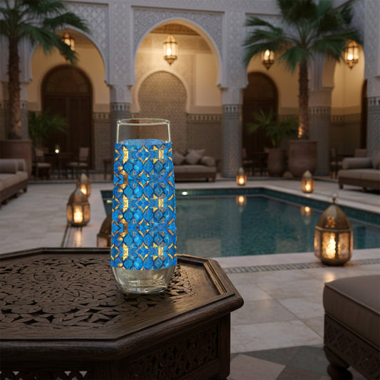 Moroccan Treasure stemless champagne glass with geometric blue and gold design sitting on a Mediterranean table with mosaic wall behind it and hanging lantern.