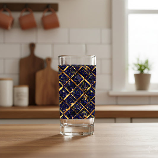 Regal Twilight highball glass with sapphire and gold wrap design on a kitchen counter