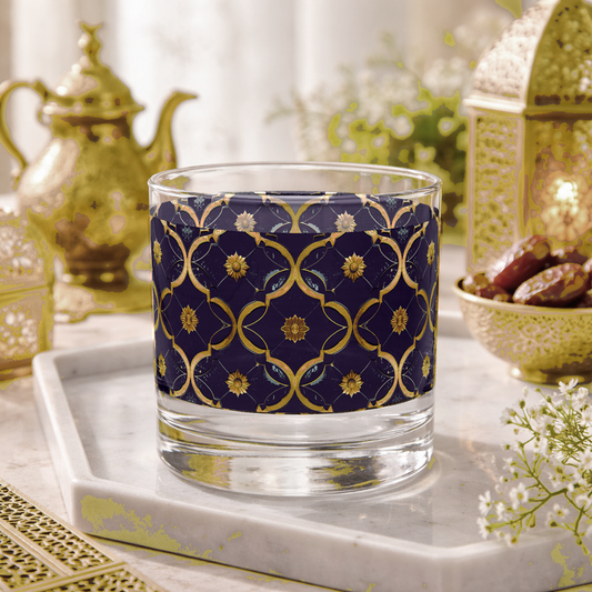 Midnight Marrakech rocks glass with a violet and gold design sitting on a marble tray with teapots and dates in the background