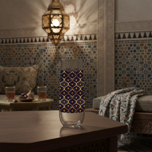Midnight Marrakech stemless champagne glass with violet and gold deisgn on a wooden table in a room with colorful tiles and a lantern.