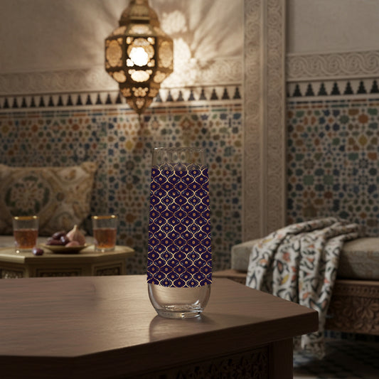 Midnight Marrakech stemless champagne glass with violet and gold deisgn on a wooden table in a room with colorful tiles and a lantern.