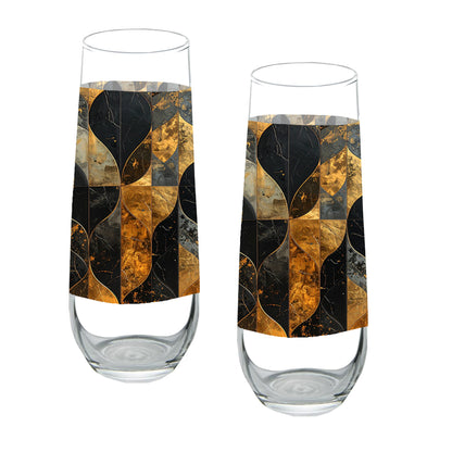 Two stemless champagne glasses with charcoal and bronze geometric design on a white background
