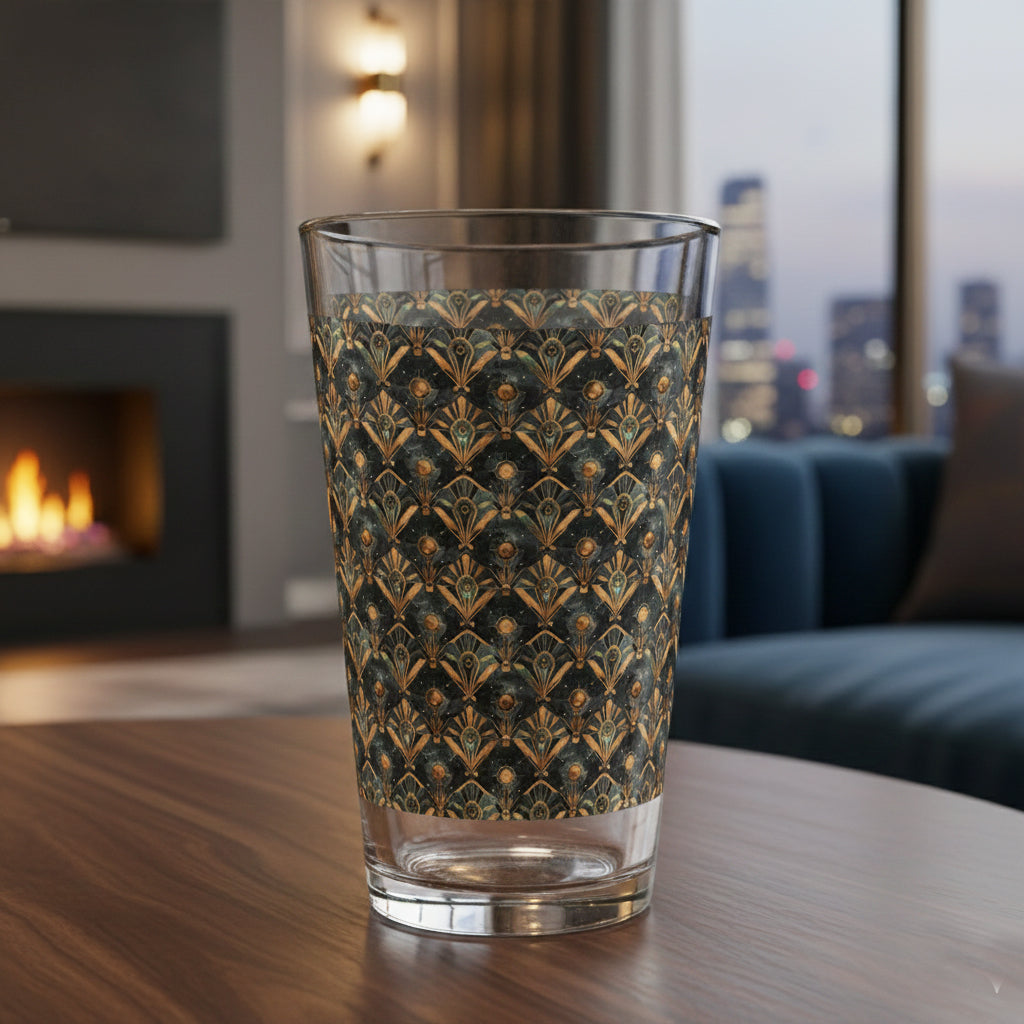Astral Glow pint beer glass with  a black and bronze design on a wooden table in a living room setting.