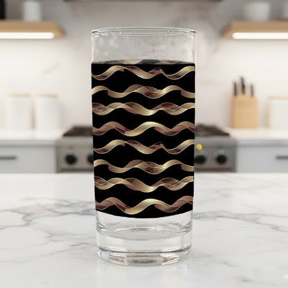 Liquid Gold highball glasses in a black and gold wavy design on a kitchen counter