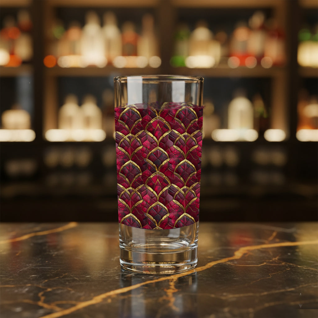 Crimson Jewels highball glass with a ruby and gold art deco design on a bar counter