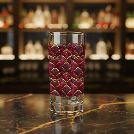 Crimson Jewels highball glass with a ruby and gold art deco design on a bar counter
