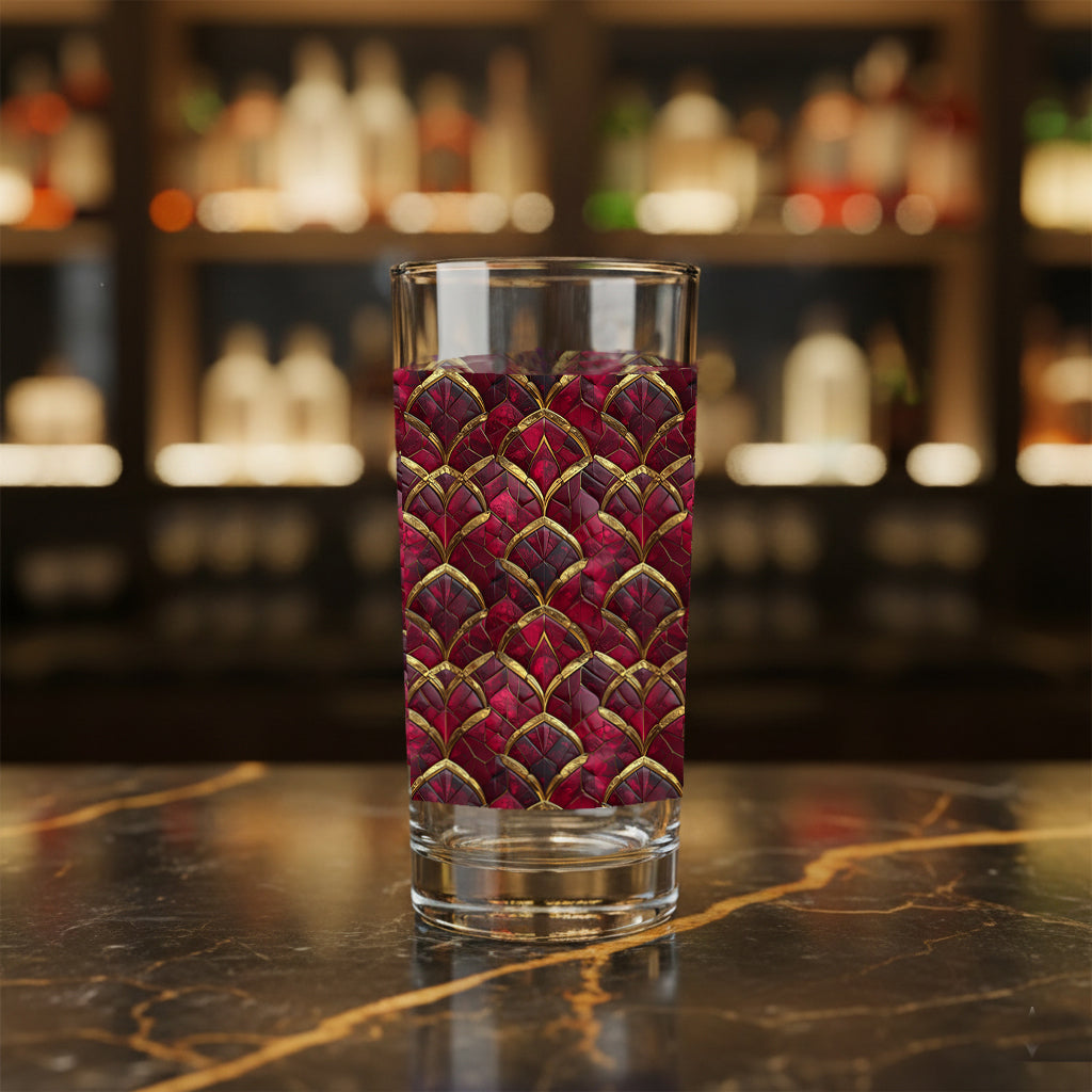 Crimson Jewels highball glass with a ruby and gold art deco design on a bar counter