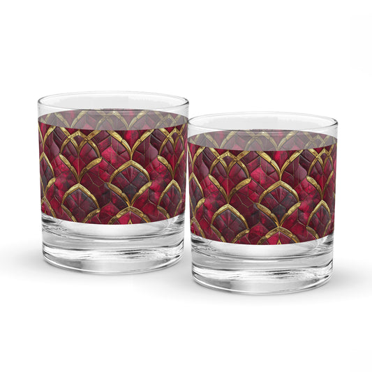 Two rock glasses with red and gold pattern on a white background
