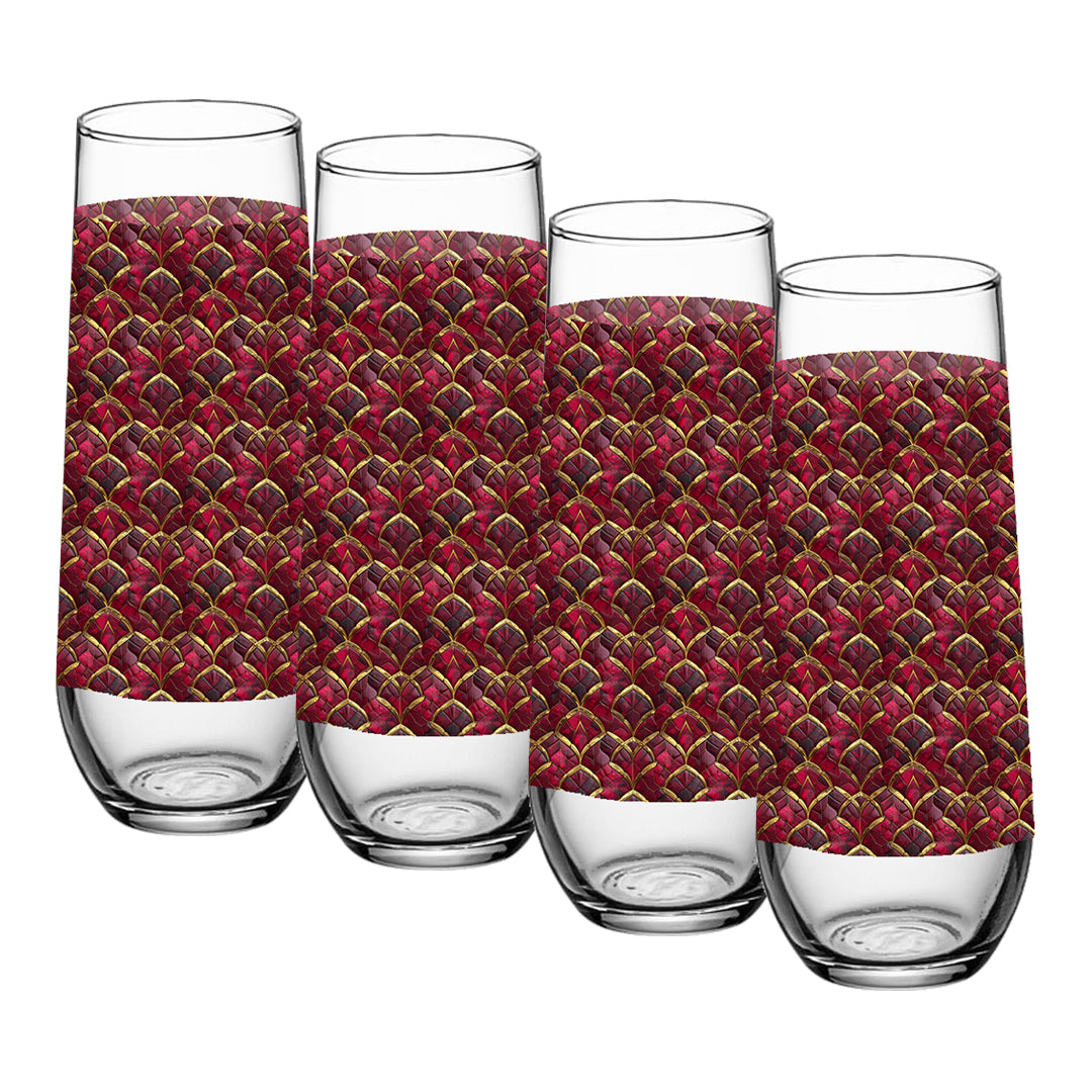 Four glass stemless champagne glasses with red and gold patterned sleeves on a white background