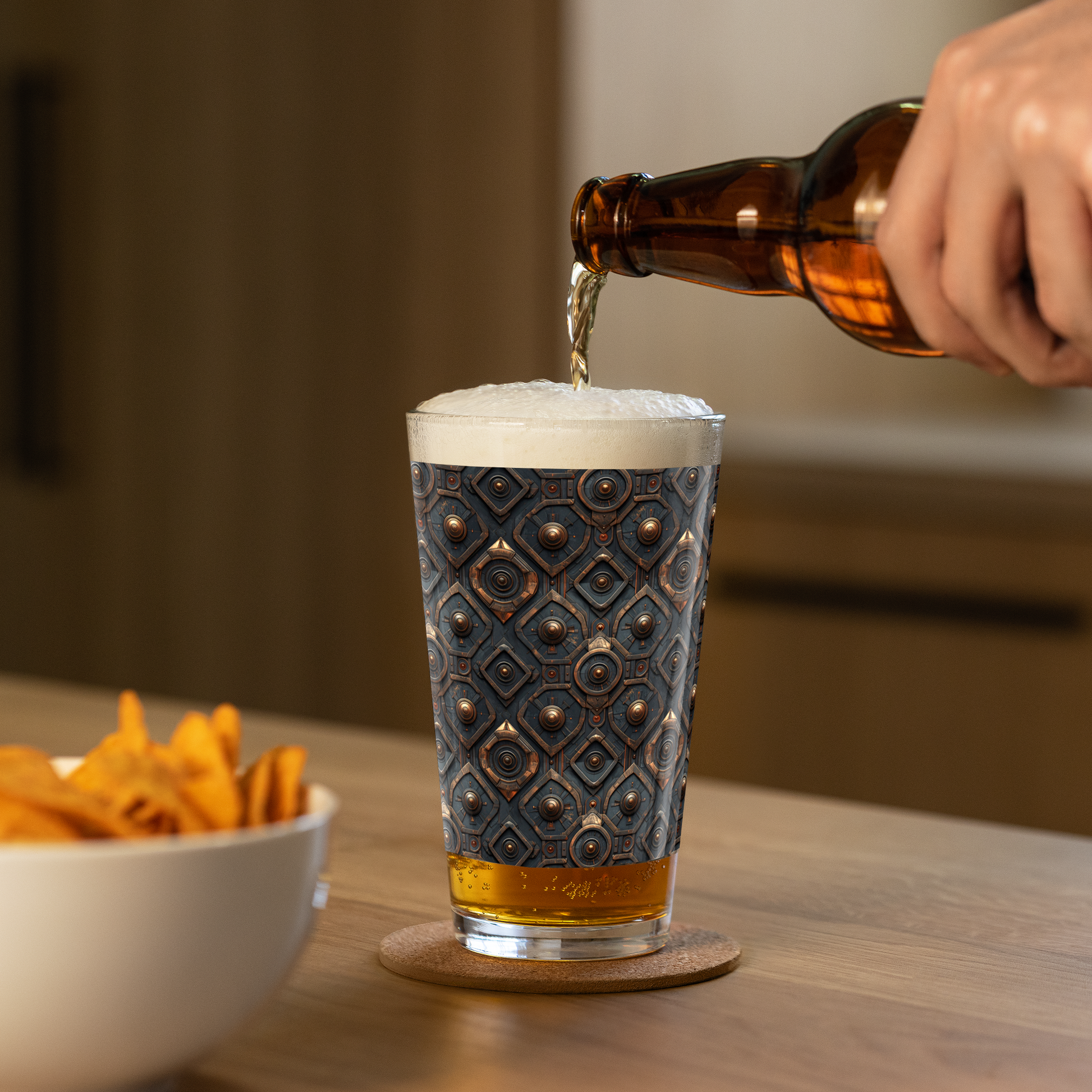 Foundtry Coppers highball glass with a dark ash discs design with a person pouring beer into the glass on a wooden table.