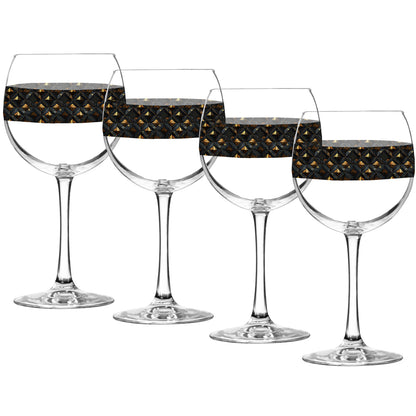 Set of four balloon wine glasses with black and gold diamond design on a white background