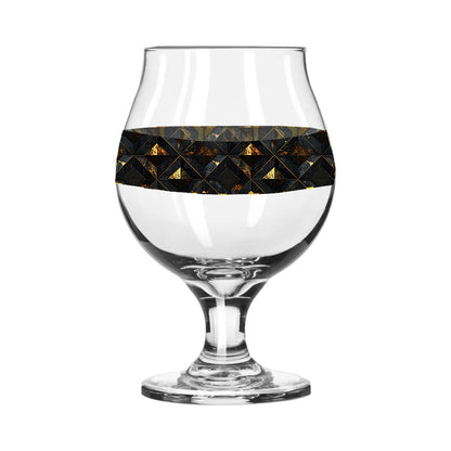 Belgian beer glass with black and gold diamond design on a white background