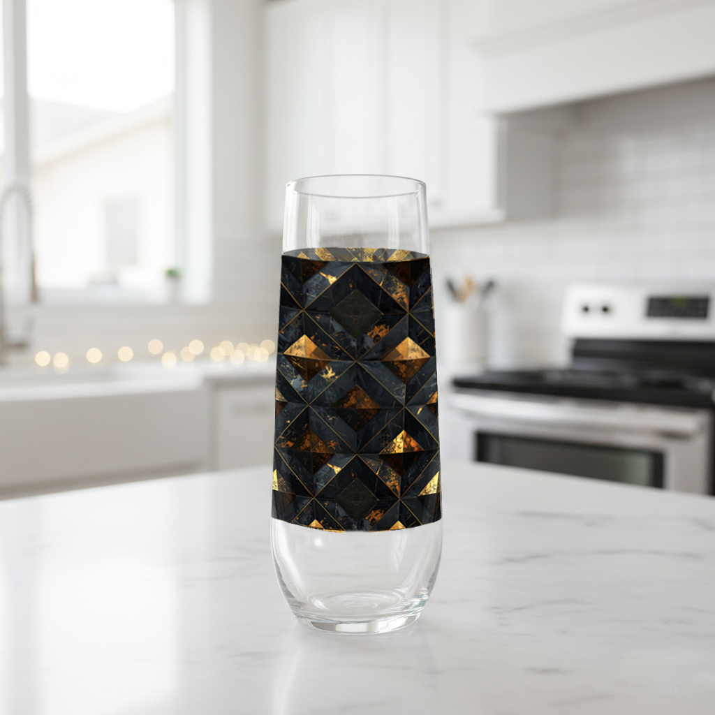 Gilded Decay stemless champagne glass with charcoal and gold geometric with black design on a kitchen counter