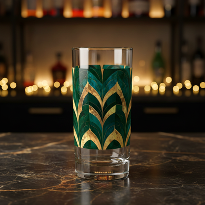 Emerald Royale highball glass with green and gold art deco design on a dark marble surface wth blurred background