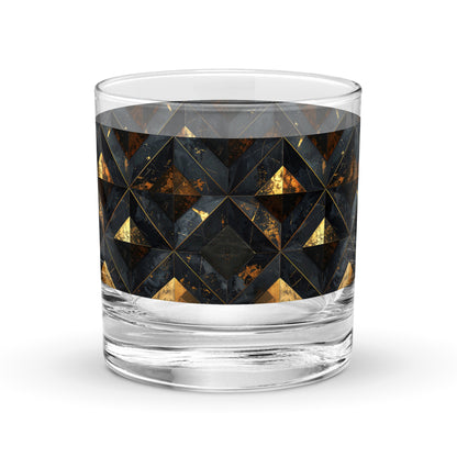 Rock glass with black and gold geometric pattern on a white background