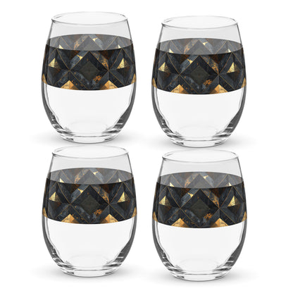 Four clear stemless wine glasses with black and gold geometric design on a white background.
