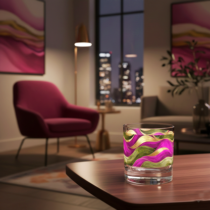 Aurelian Dusk rock glass with magenta, gold, olive design ad filled with ice on a table in a stylish living room with cityscape view.