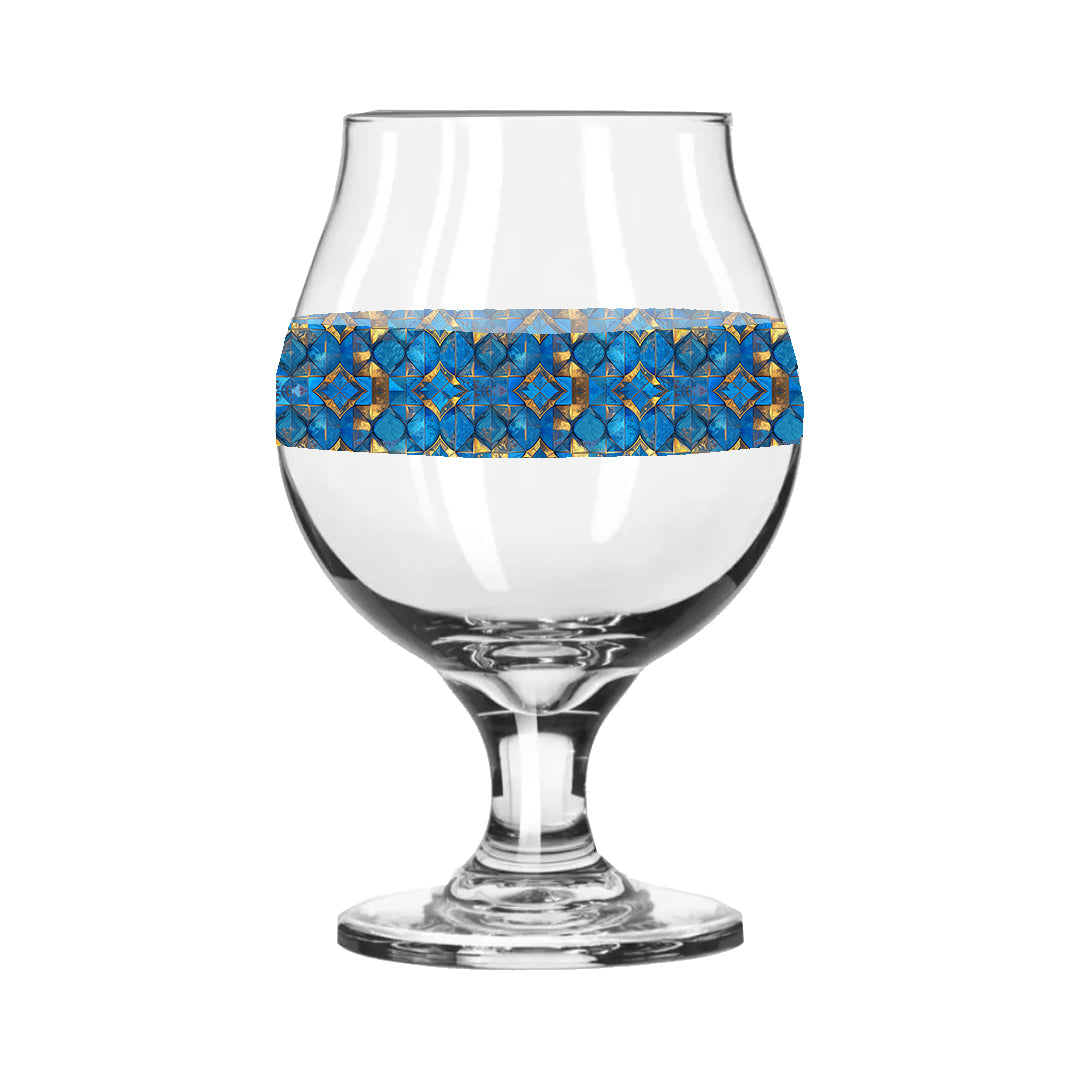 Belgian beer glass with turqoise and gold geometric design on a white background