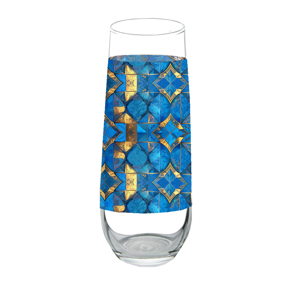 Stemless chmpagne glass with turqoise and gold geometric design on a white background