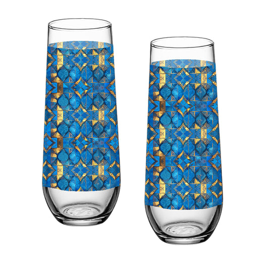 Two stemless champagne glasses with turqoise and gold geometric design on a white background