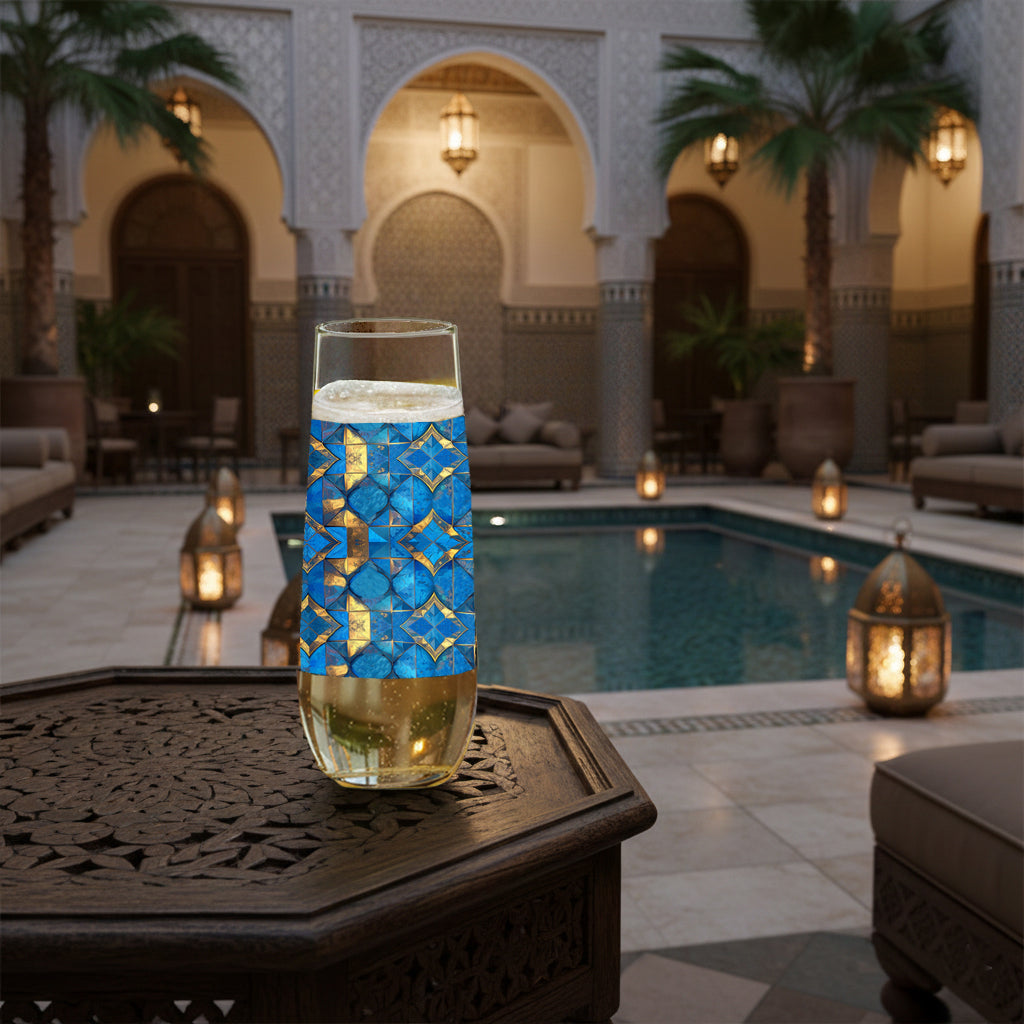 Moroccan Treasure stemless champagne glass with geometric blue and gold design on a table by a poolside in a outdoor setting