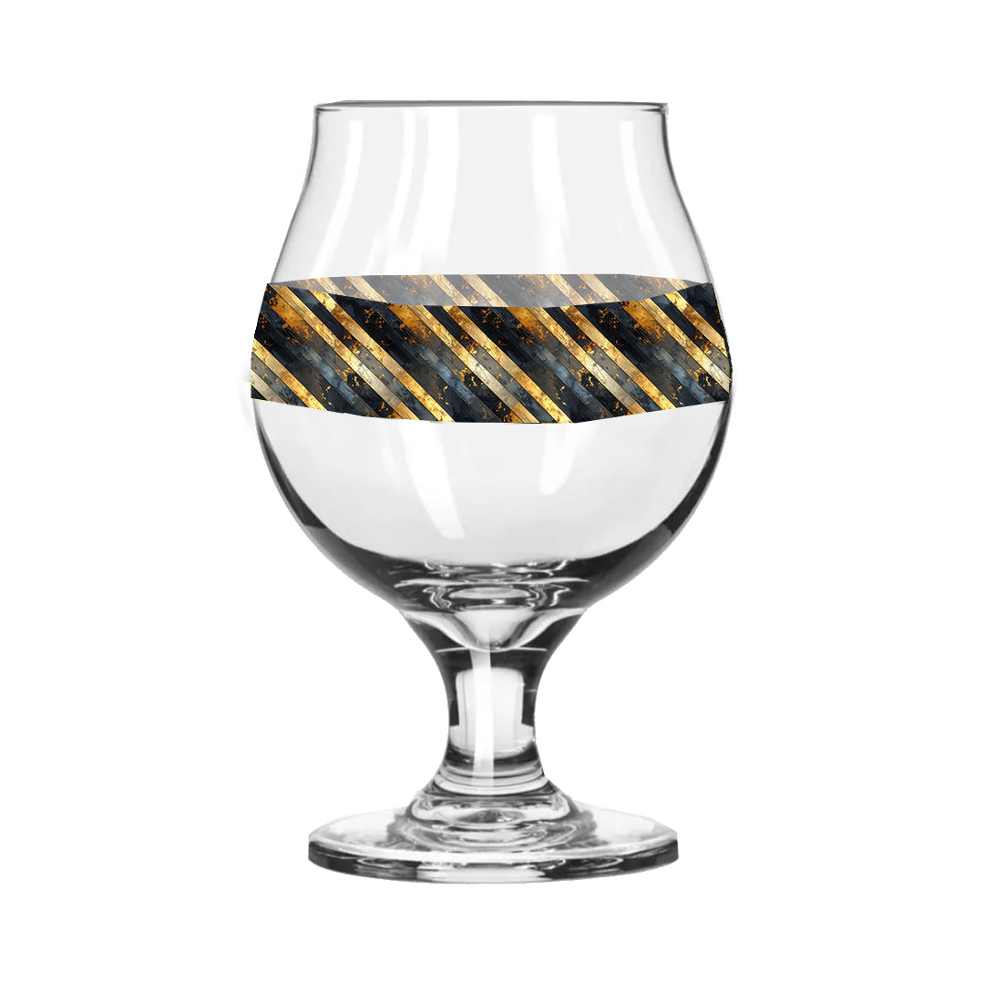 Belgian beer glass with black and gold striped pattern on a white background
