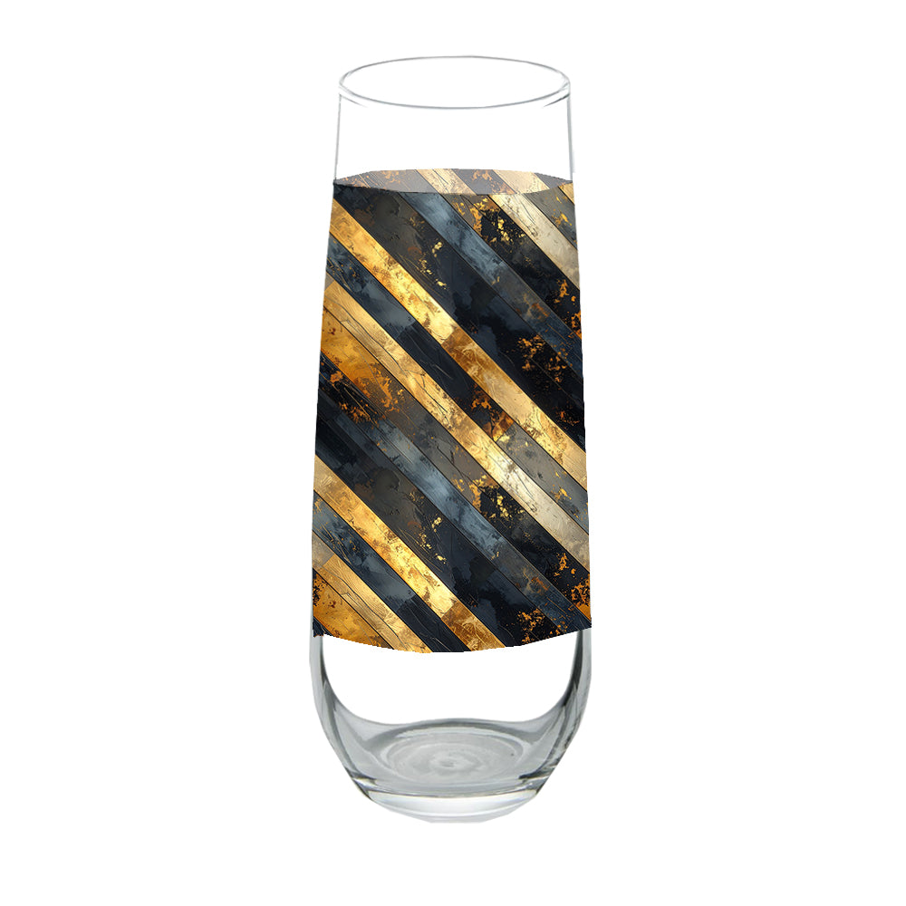 Stemless champagne flute glass with black and gold striped design on a white background