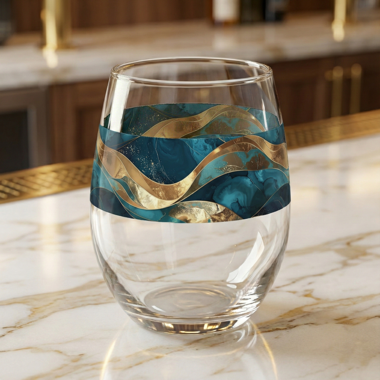 Opulent Teal stemless wine glass on a marble countertop, featuring  teal, turquoise, and gold waves design.