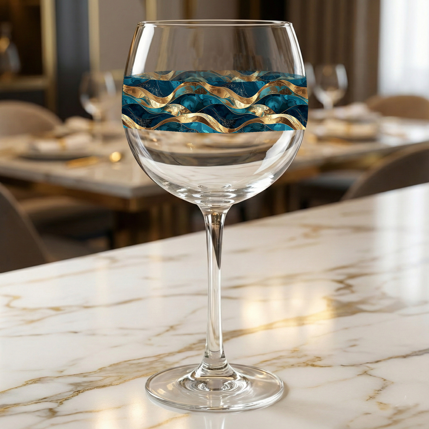 Opulent Teal balloon wine glass with teal and gold design on a marble surface