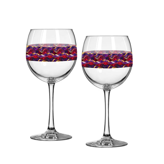 Two balloon wine glasses with purple and gold wavy design on a white background