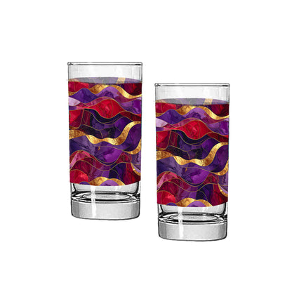 Two highball glass eswith colorful purple and gold wave pattern on a white background  