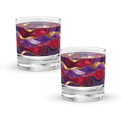 Two rock glasses with purple and gold colorful wavy pattern on a white background