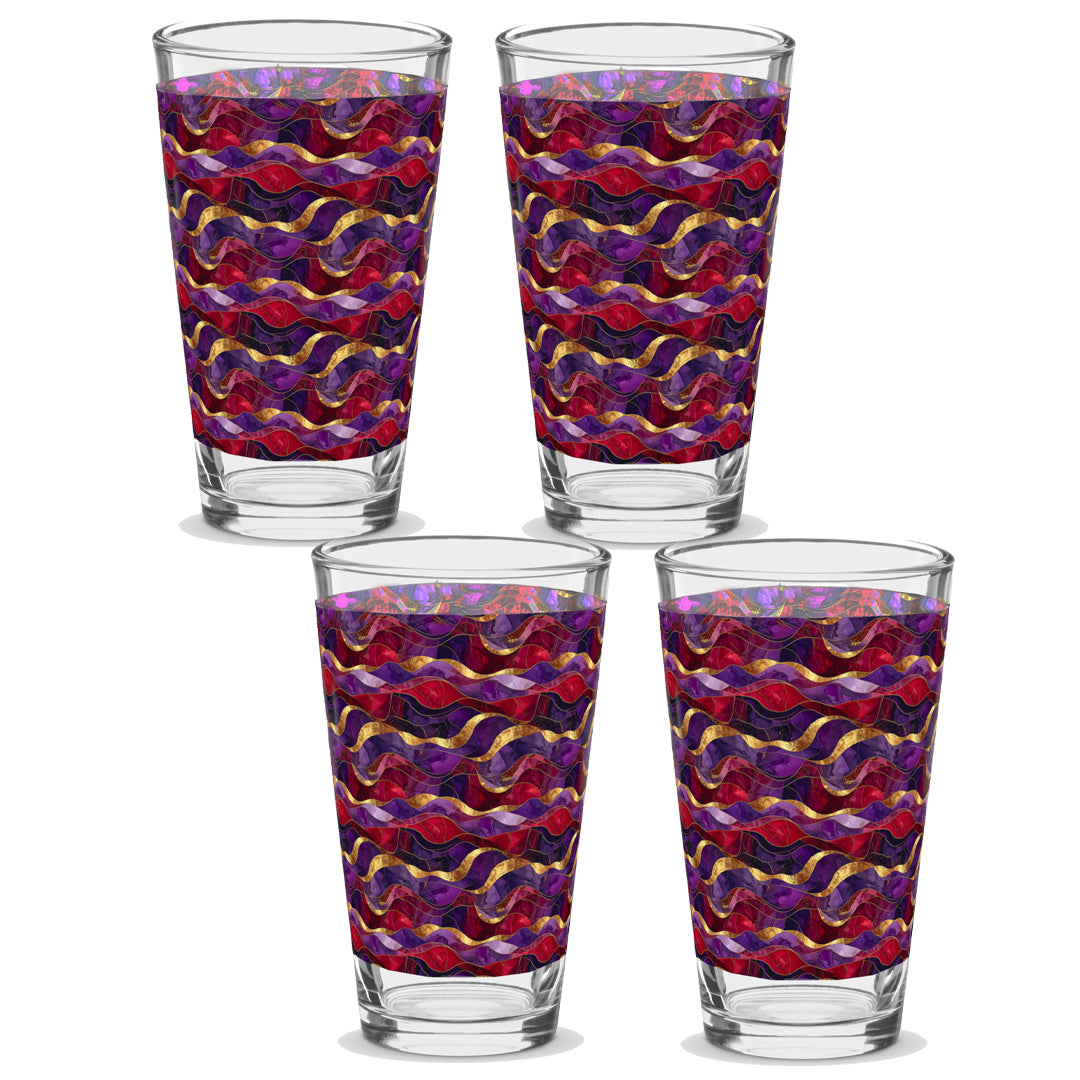Four glass tumblers with a colorful wavy pattern on a white background