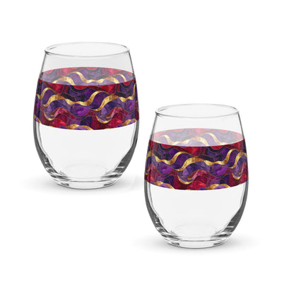 Two clear stemless wine glasses with purple and gold colorful pattern on a white background