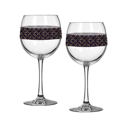 Two balloon wine glasses with sapphire and gold wrap design on a white background