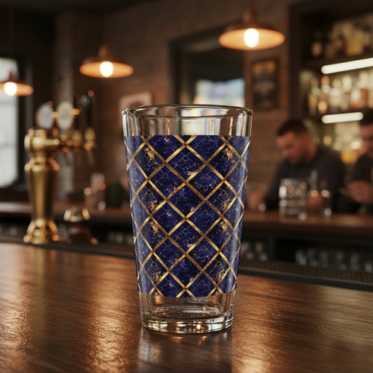 Regal Twilight clear pint beer glass with sapphire and gold wrap design sitting on a bar counter
