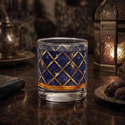 Regal Twilight rocks glass with sapphire and gold wrap design on a dark surface wotj dates amd a lantern