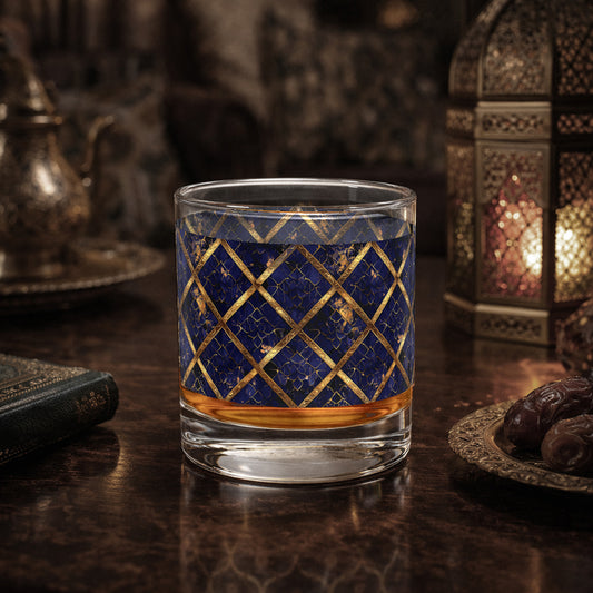 Regal Twilight rocks glass with sapphire and gold wrap design on a dark surface wotj dates amd a lantern