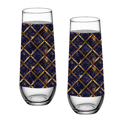 Two stemless champagne glasses with sapphire and gold wrap design on a white background