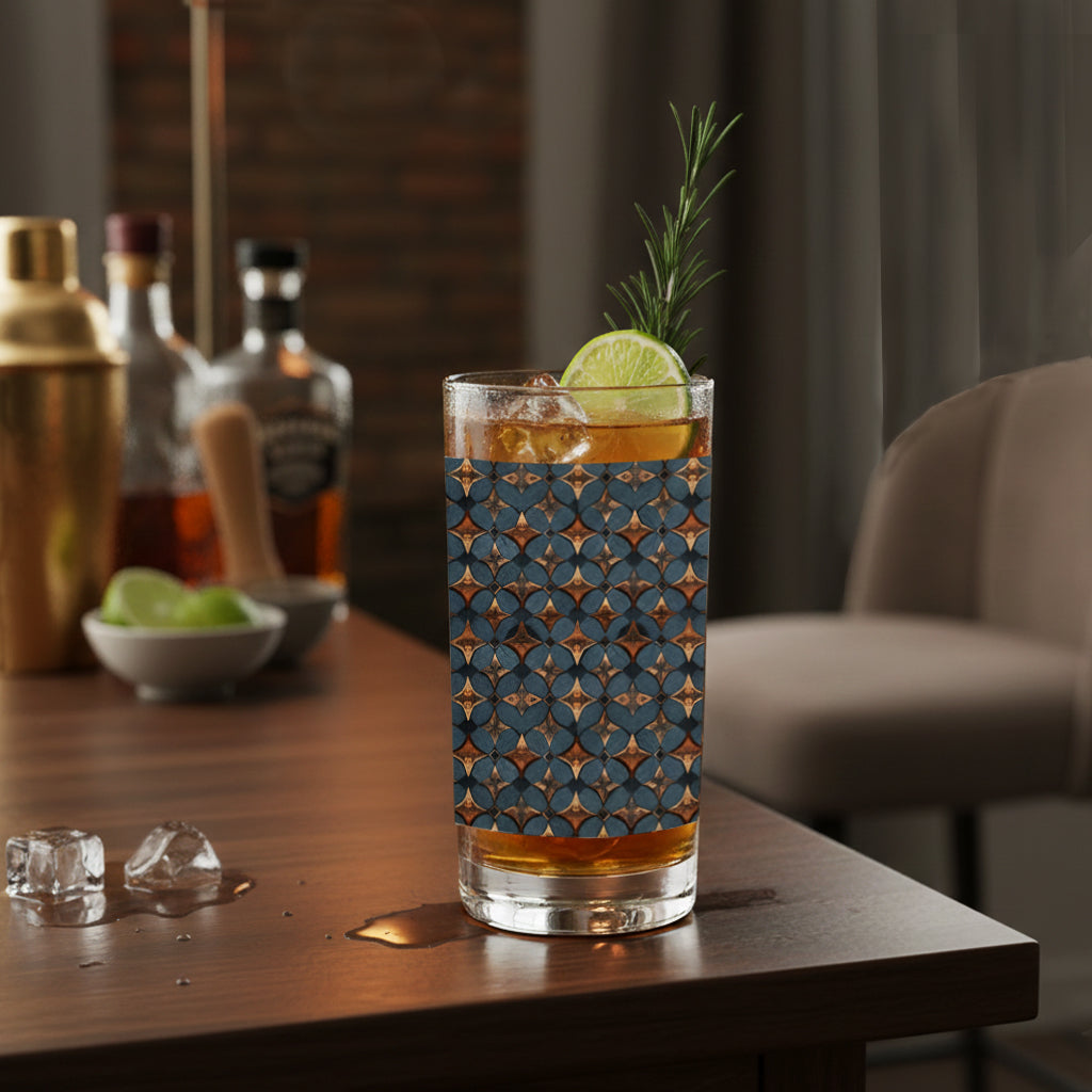 Burnished Slate highball glass with slate and copper design, filled with a cocktail and lime and rosemary garnish that's sitting on a home bar.