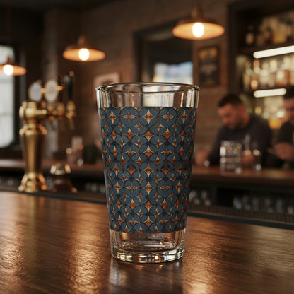 Burnished Slate pint beer glass with slate blue and copper design on a bar counter with a blurred bar setting in the background