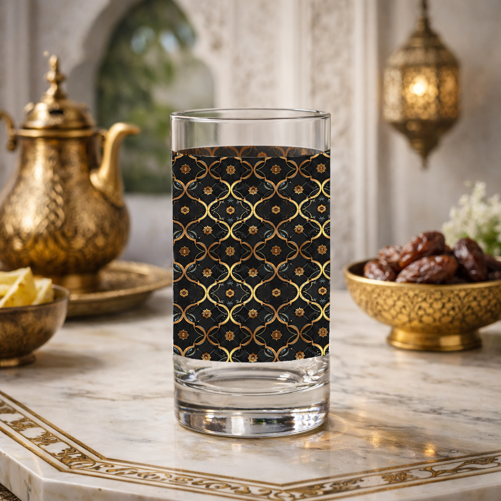 Midnight Marrakech highball glass with a black and gold design on a marble table with Moroccan decorative items.