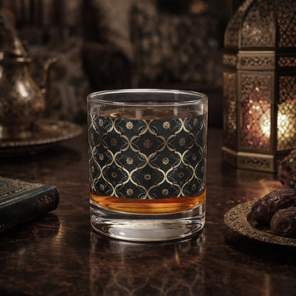 Midnight Marrakech rocks glass with a black and gold design sitting on a wooden surface with decorative elements.