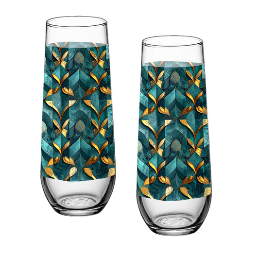 Two stemless champagne glasses with teal and gold geometric pattern on a white background