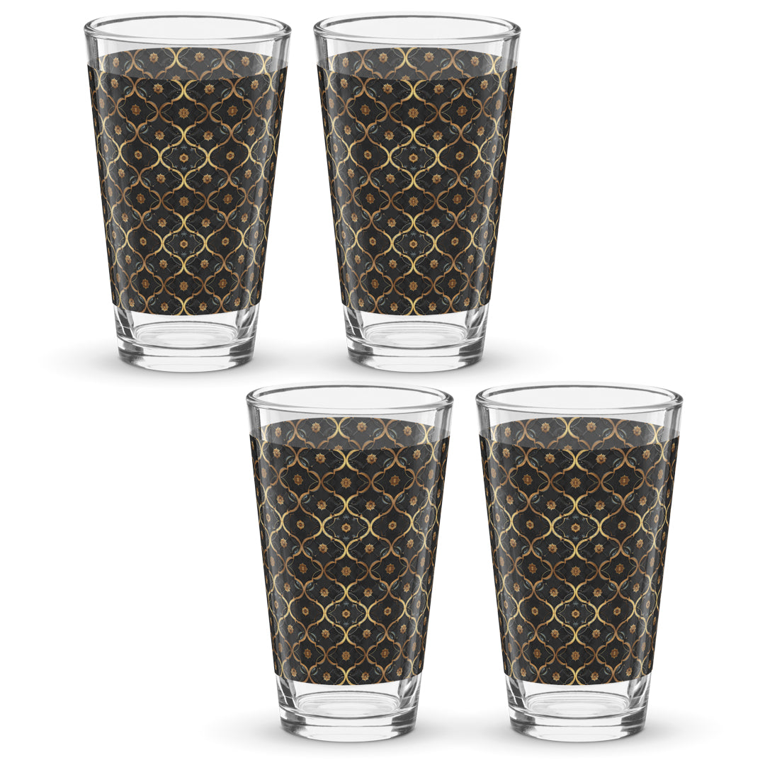 Four pint beer glasses with violet and gold pattern on a white background