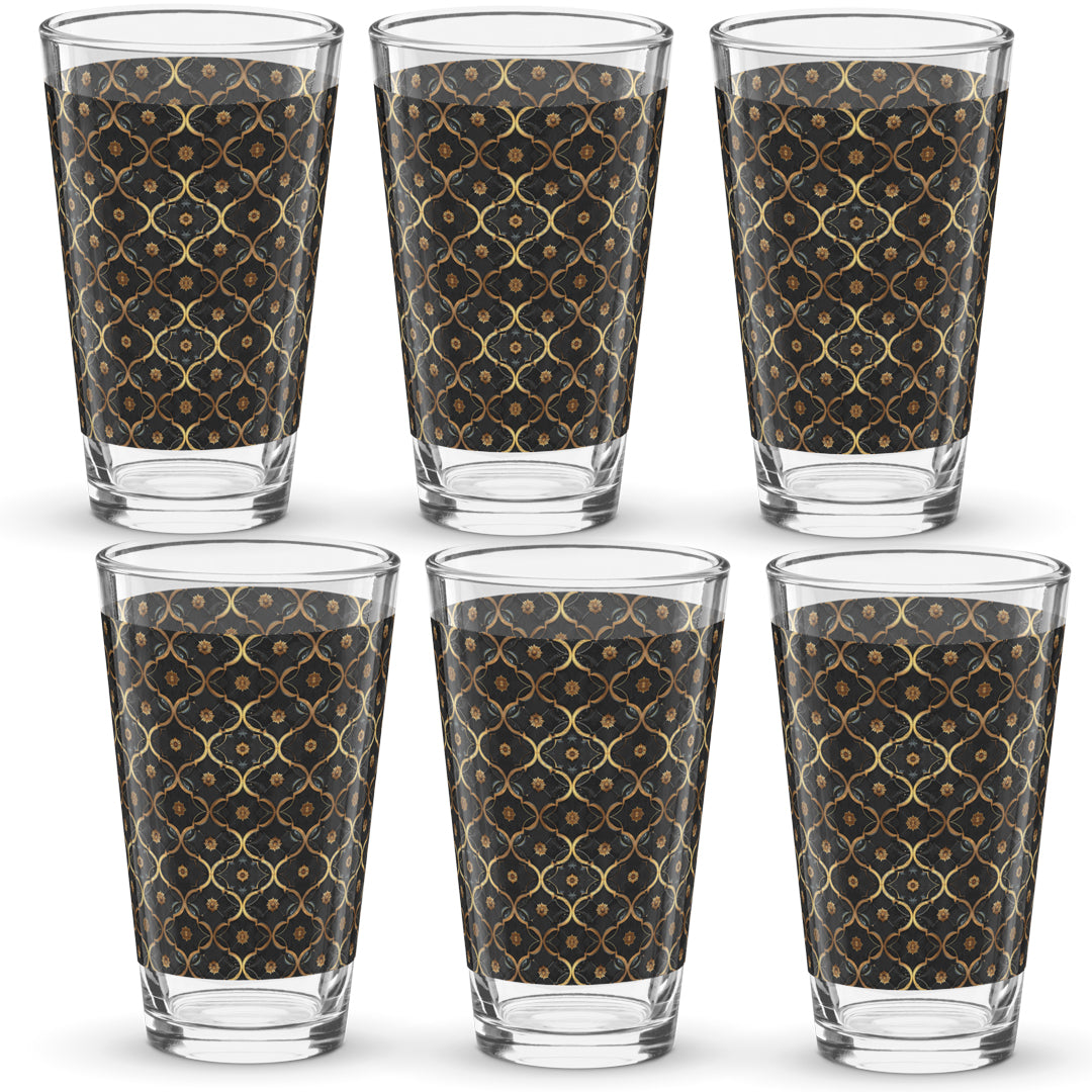 Set of six pint beer glasses with violet and gold pattern on a white background