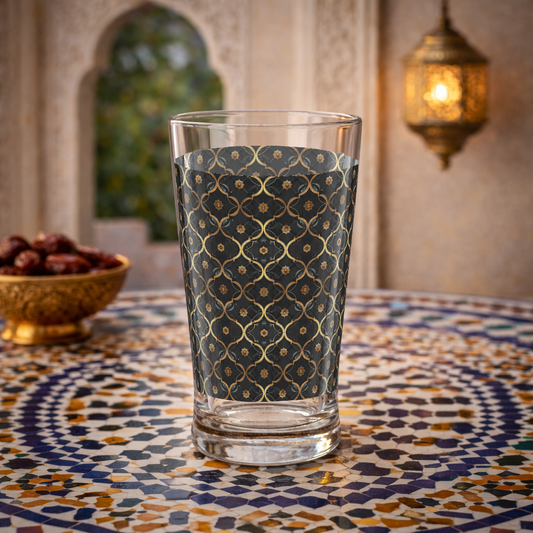 Midnight Marrakech pint beer glass with violet and gold design sitting on a Moroccan mosaic table