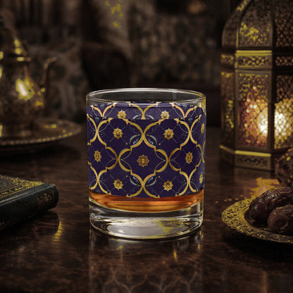 Midnight Marrakech rocks glass with a violet and gold design sitting on a wooden surface with decorative elements.